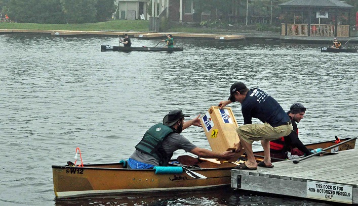 Voyageur team Paddlin' YakaChap picks up their crate from Rob Horton at the Town Dock (Photo: Cheyenne Wood)