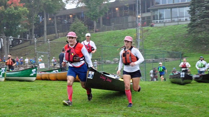 Team #wepaddletogether, Mike and Lexy Vincent from Regina SK, run toward Peninsula Lake (Photo: Cheyenne Wood)