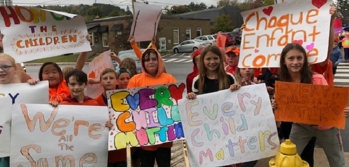 Huntsville Public School students with the signs they created for Orange Shirt Day