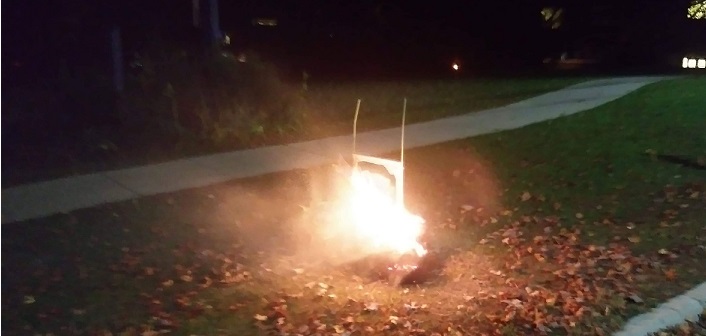 This burning hay bale holding an election sign near HHS was extinguished by passersby and an OPP officer. (Photo: Steve Rowan)