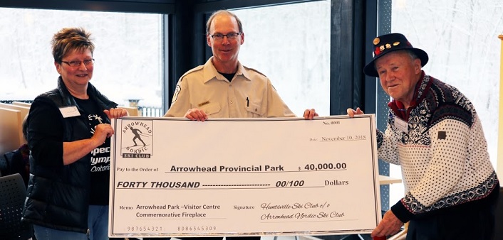 Cindy Blake (left), treasurer of Arrowhead Nordic Ski Club and Bob Hutcheson, representing the former Huntsville Ski Club, present a cheque to Peter Briand, Park Superintendent, Arrowhead Provincial Park (Photo: Don McCormick)