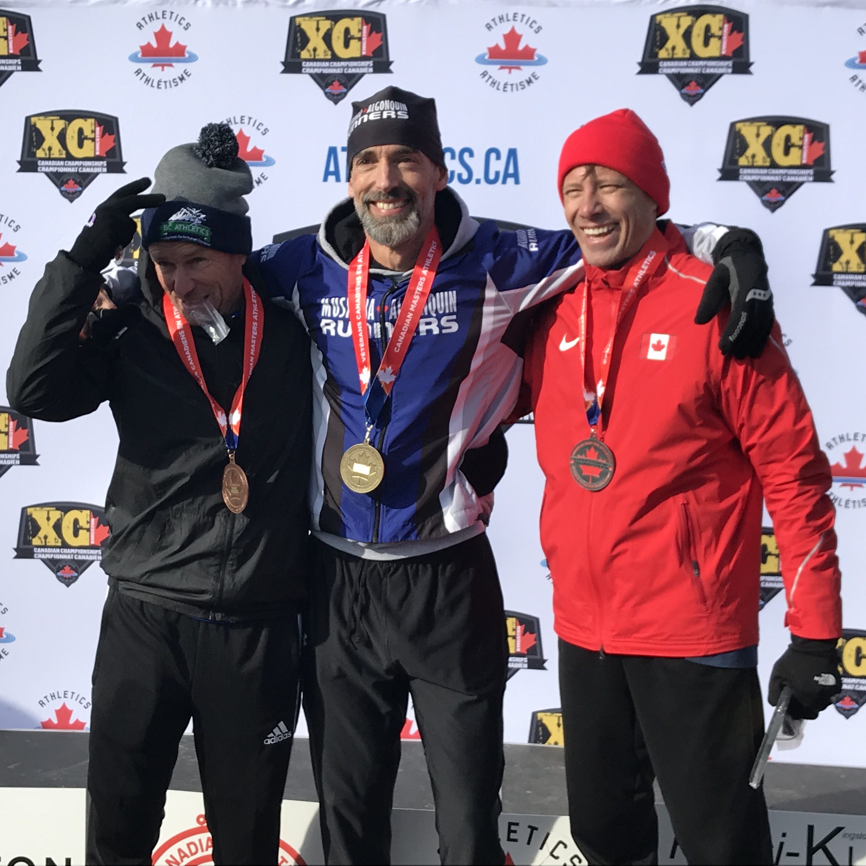 Troy Cox (centre) M50-54 winner