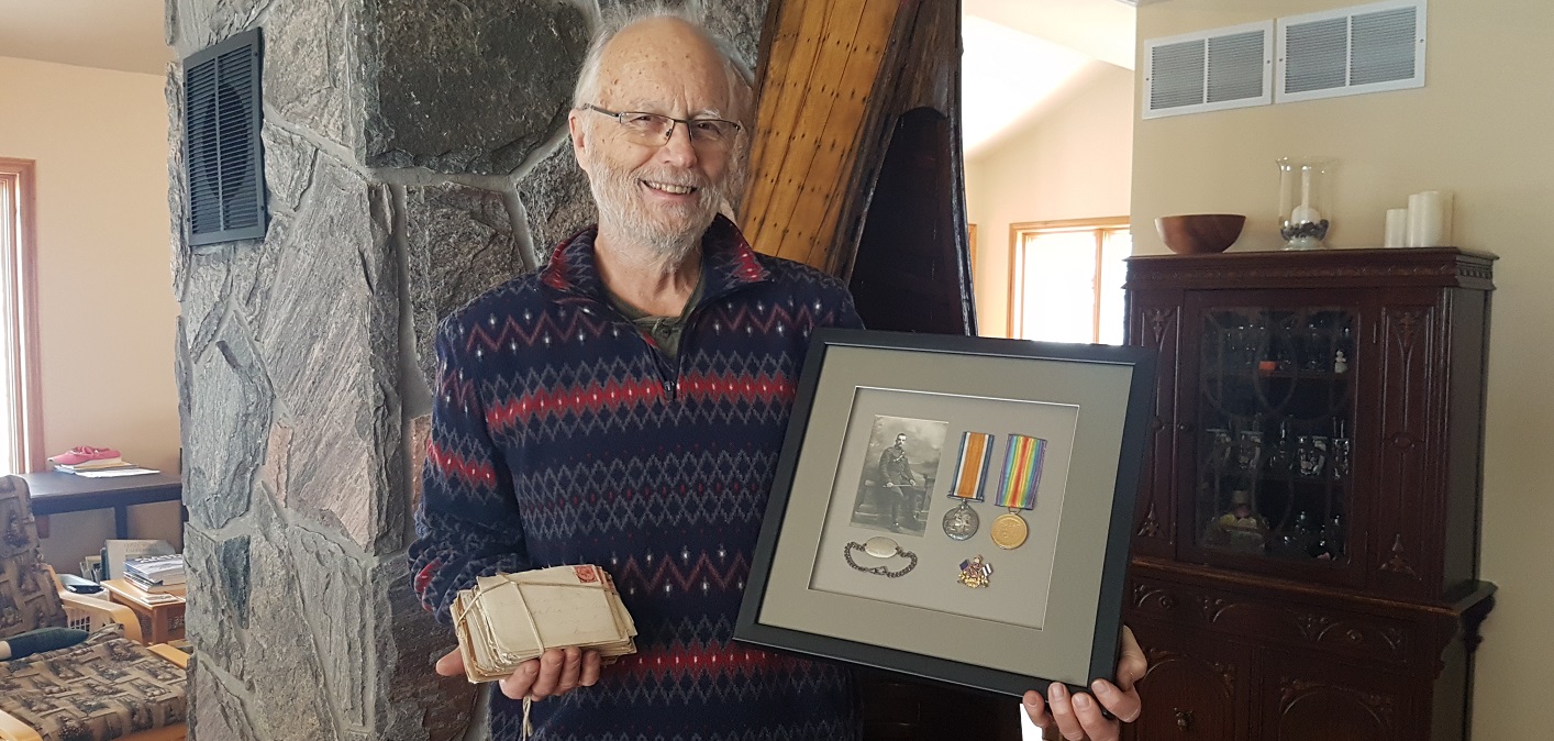 Scott Winchester with his grandfather’s WWI service medals and letters home