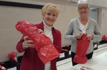 Sylvia Wookey and Sharon Upham are all smiles as they wrap the stockings