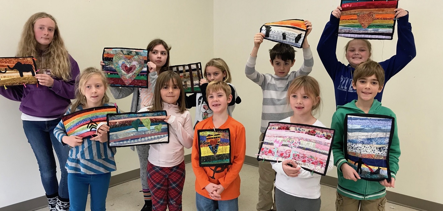 Kids Sewing Workshop participants show off their creations