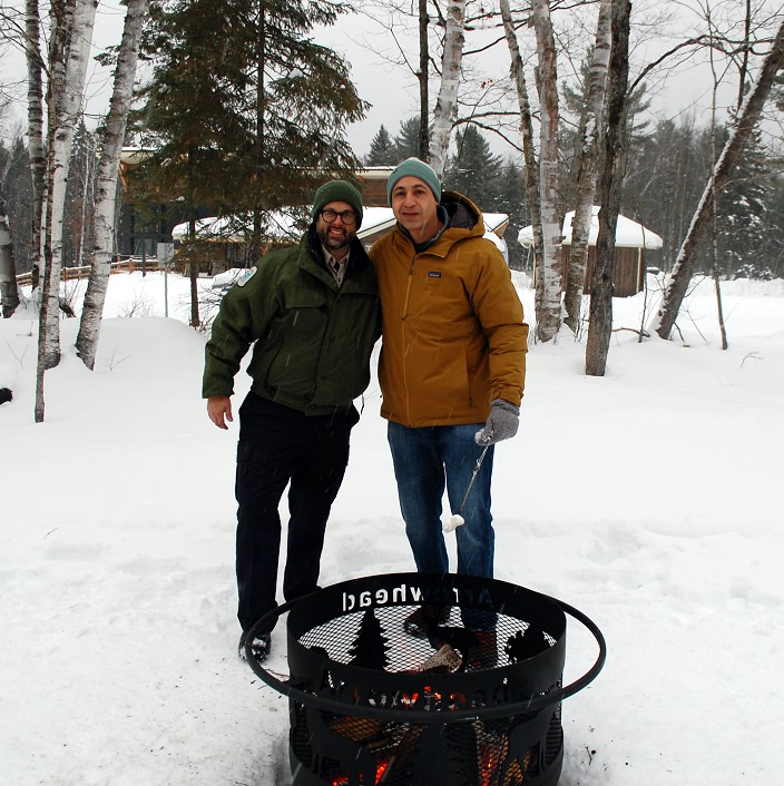 Ontario Parks staff member Brad Steinberg (left) and Niv Froehlich make s'mores