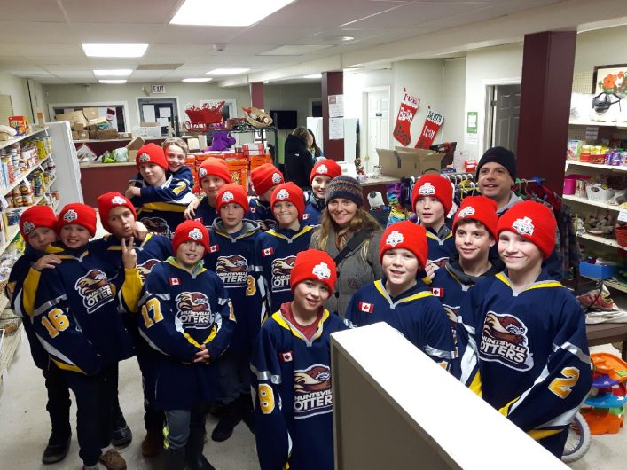The Huntsville Peewee Rep Otters with The Table CEO Heather Berg (centre) at the organization's food bank (Photo: Vicky Perentesis)