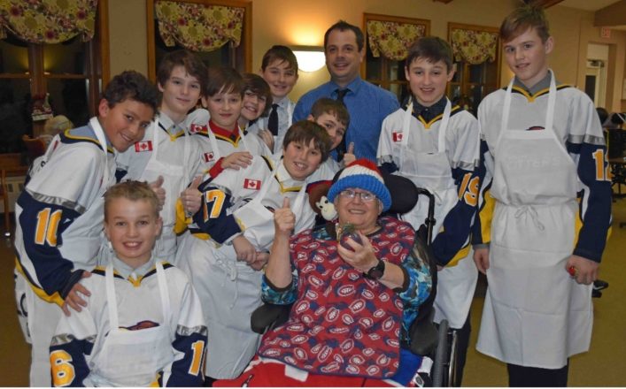 The Peewee Rep Otters with resident Penny Reuvekamp and the Christmas ornament they gave her. "I hope these young lads stay this way," she said.