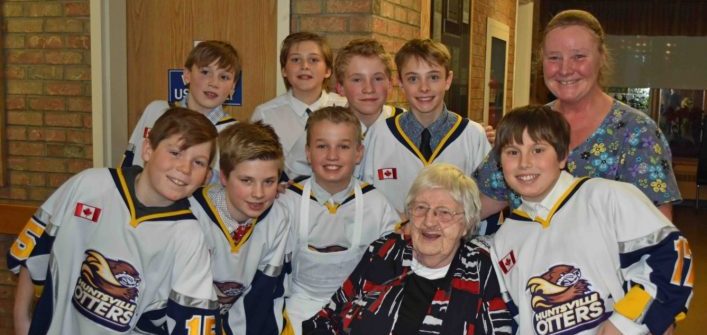 The Huntsville Peewee Rep Otters with Fairvern resident Elizabeth Boothby and dietary aide Sam Leslie