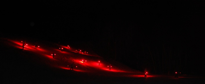 Skiers descend the Flying Dutchman in a beautiful parade of lights