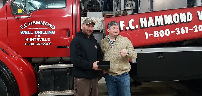 Jeff Yearley (left) and Mayor Scott Aitchison draw the lucky winner in the annual F.C. Hammond well draw