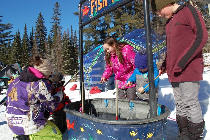 The fishing booth delighted young anglers (from left) Farrah Dukoff with Parker Cousintine, Jo-Leigh Armour, Hudson Dwyer, and Jacob Wright