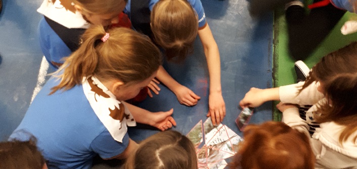 Girls from local Girl Guides groups work together to complete a puzzle on World Thinking Day (supplied)