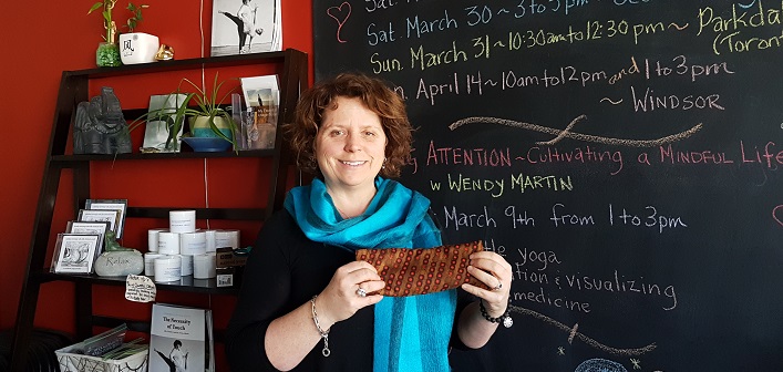 Allie Chisholm-Smith at Ahimsa with an eye bag like the ones she is donating for use at Beaver Creek Institution