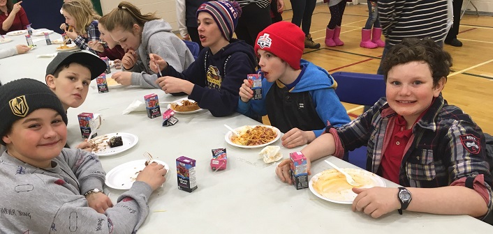 (Foreground from left) Kai, Hunter, Noah, Jared, and Jonah enjoy the annual HPS spaghetti dinner (supplied)