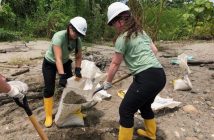 HHS ME to WE team members Sydney Austrup (left) and Madi Buck shovel gravel for the school build in Ecuador (supplied)