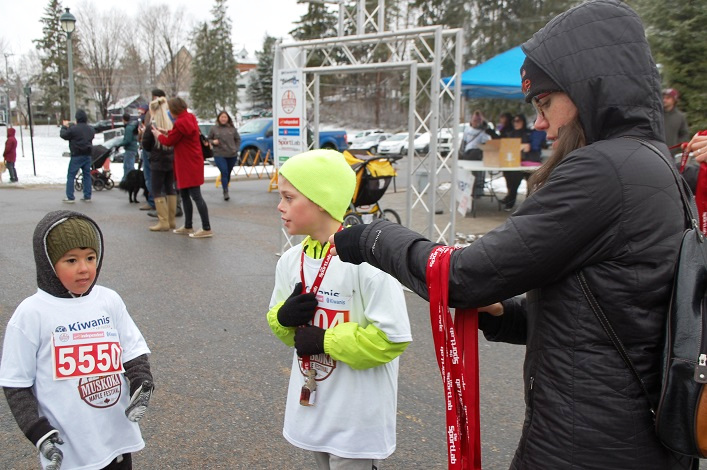 The first two finishers in the younger age category receive their medals
