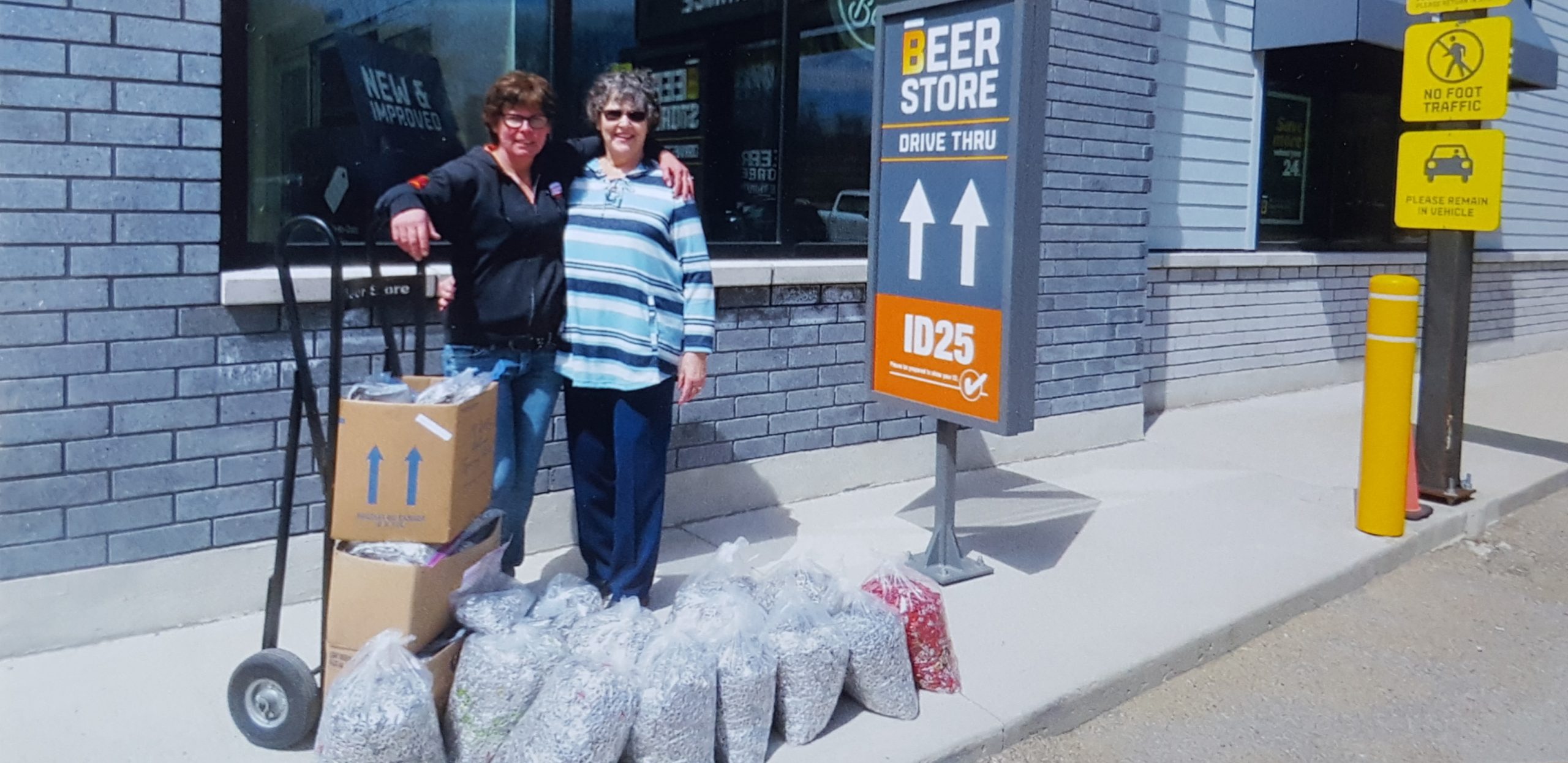 Nicole Bower (left), an employee at The Beer Store, and Karen Hewitt, a volunteer with the Friends of Fairvern, with some of the tabs collected