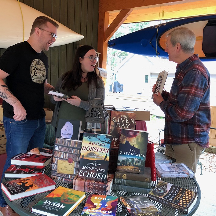 John Francis (right) selling books at the book sale (supplied)