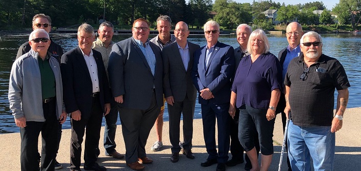 Those present for the announcement by Minister Clark (centre front)  included MPP Norm Miller, area mayors, and District councillors and staff (supplied)