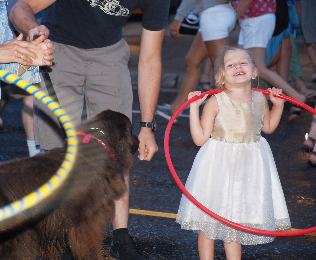 Molly Morrison, 4, was having a blast hula hooping while her dog Hunter watched.