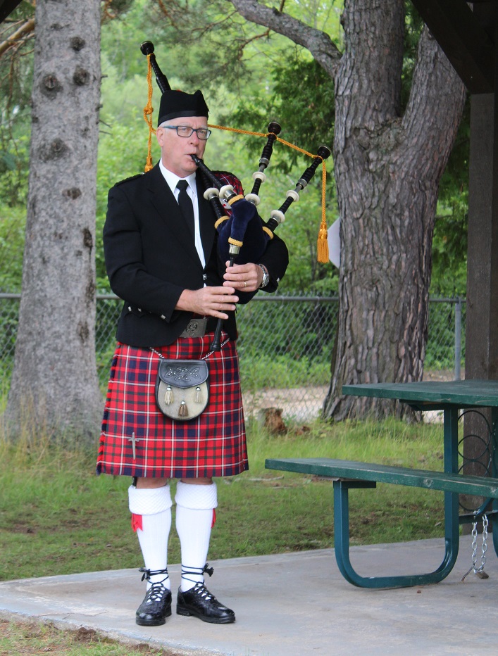 Piper Brian Raaslaub drives from Toronto to volunteer his time to pipe the paddlers off
