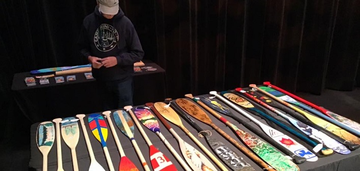 A potential bidder checks out the paddles up for auction at the Algonquin Theatre (Photo: Randy Mitson)