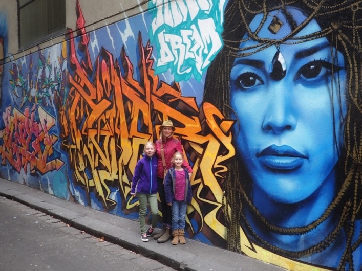 (From left) Joan, Mara and Ellie in front of some Melbourne street art (supplied)
