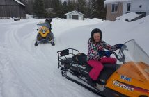 Ella (front) takes a snowmobile for a spin (supplied)