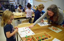 Libs is very attentive to her students. Here she helps Ember make a symmetrical pattern on a butterfly.