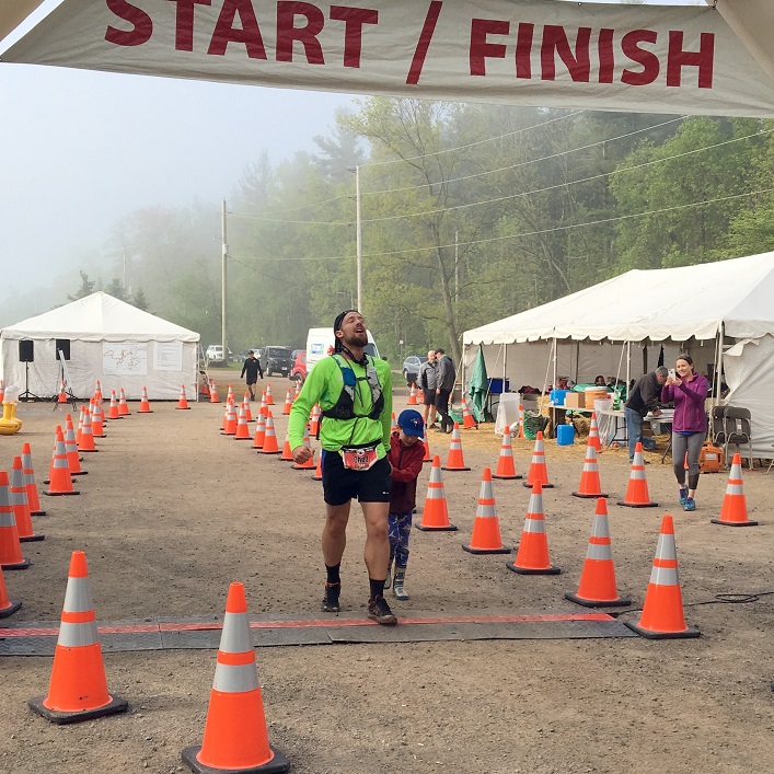Chad finishing his first 100-mile race with his son at his side (Courtesy of Chad Barber)