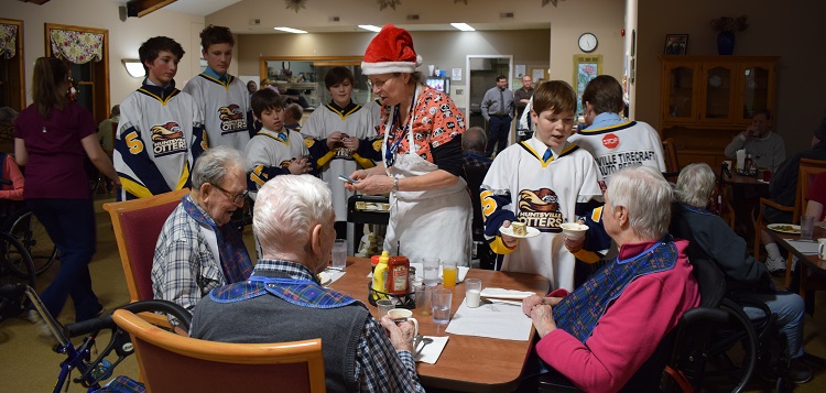 Owen Decaro (second from right) serves dessert to Irene Smith (Mandi Hargrave)