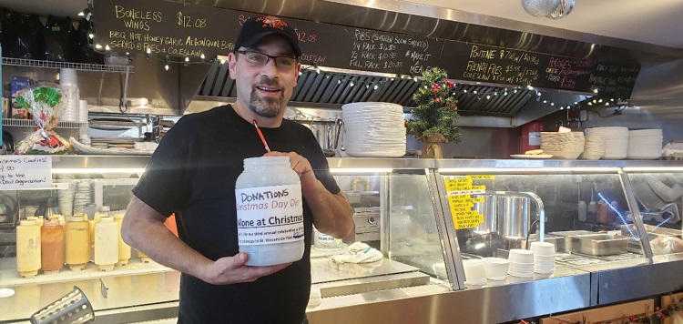 Shaun Israelstam holds the donation jar at Algonquin Café (Mandi Hargrave)