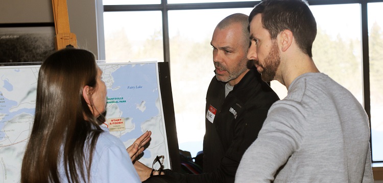 Nick Stoehr (centre) of TriSport talks about the proposed run route with a local resident (Don McCormick)