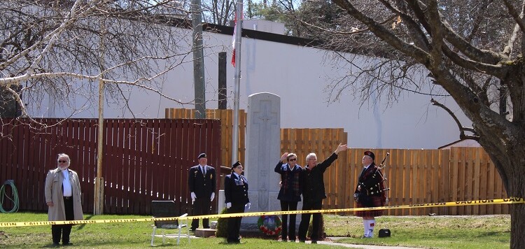 Marion and Rick Boddy wave thanks to supporters driving by the cenotaph at the Huntsville Legion