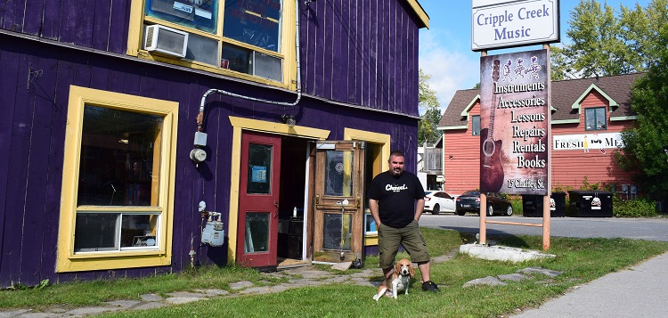 Mike McAvan and Gunner are ready to welcome old and new customers to Cripple Creek Music (Mandi Hargrave)