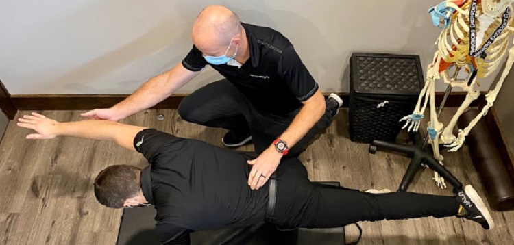 Reactivate chiro – Dr. Travis Bissonette works with a patient