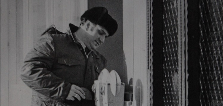 Ray Porter checks a parking meter in his former role as a Town of Huntsville bylaw officer (file photo)