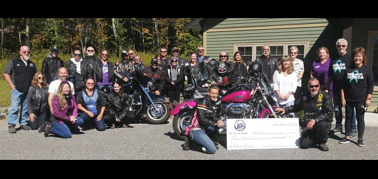 Ride for Rhonda participants present a cheque to Hospice Huntsville staff (supplied)