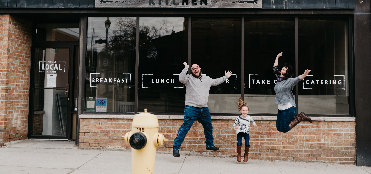 (From left) Ryan, daughter, and Christina Clarke are jumping for joy at Main St Local’s five-year anniversary (Danielle Taylor)