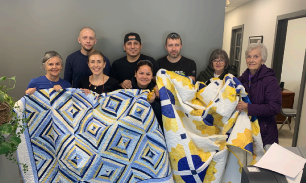 Aspdin quilters gift quilts welcoming newcomers to the community