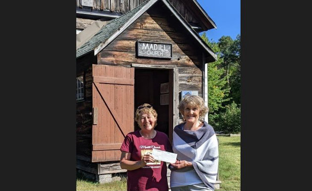 Alcock presents cheque to Madill Church Preservation Society at AGM